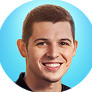 Portrait of a smiling man with short brown hair against a light blue circular background.